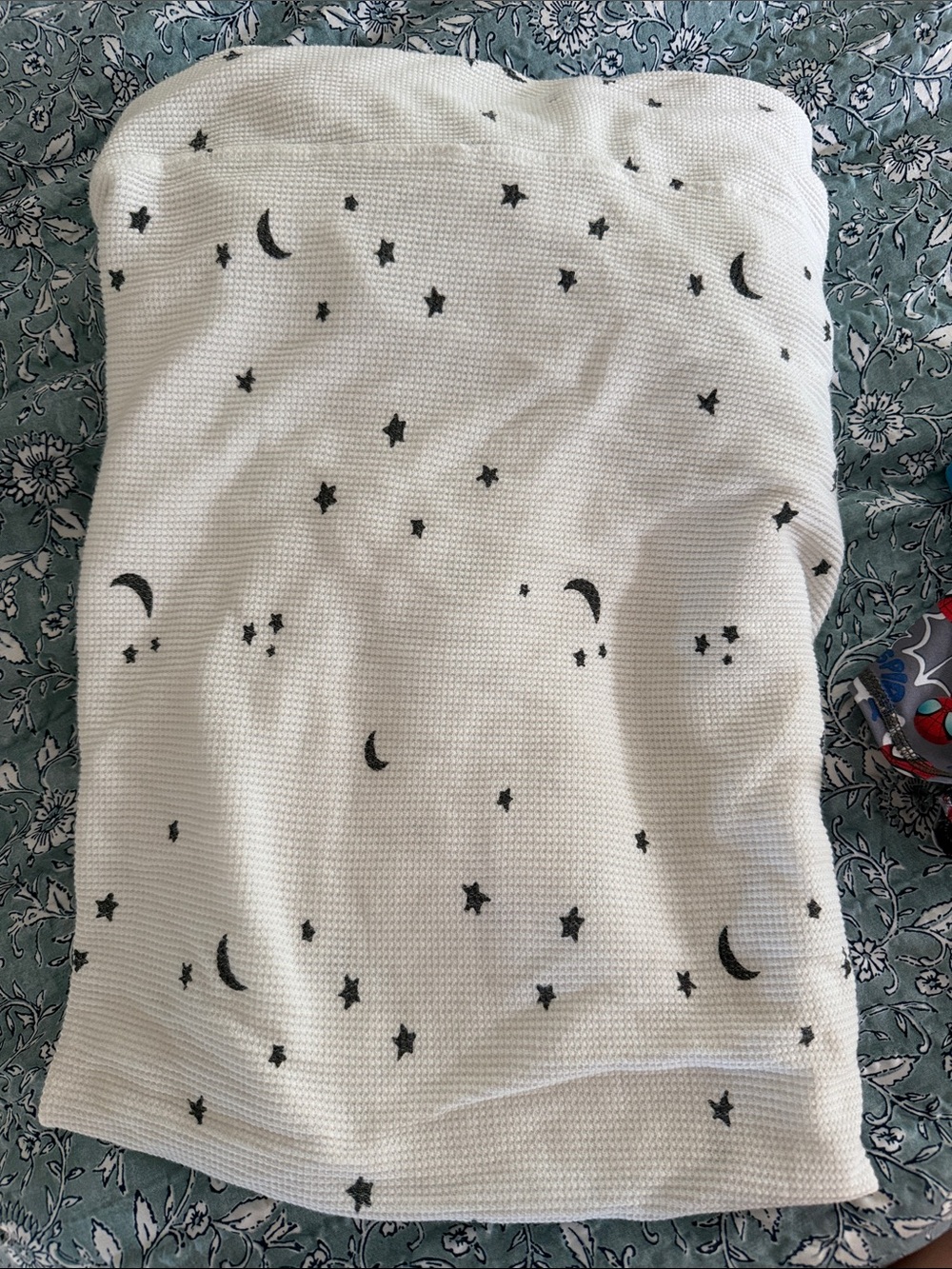 kate quinn white baby blanket with black moon and star print